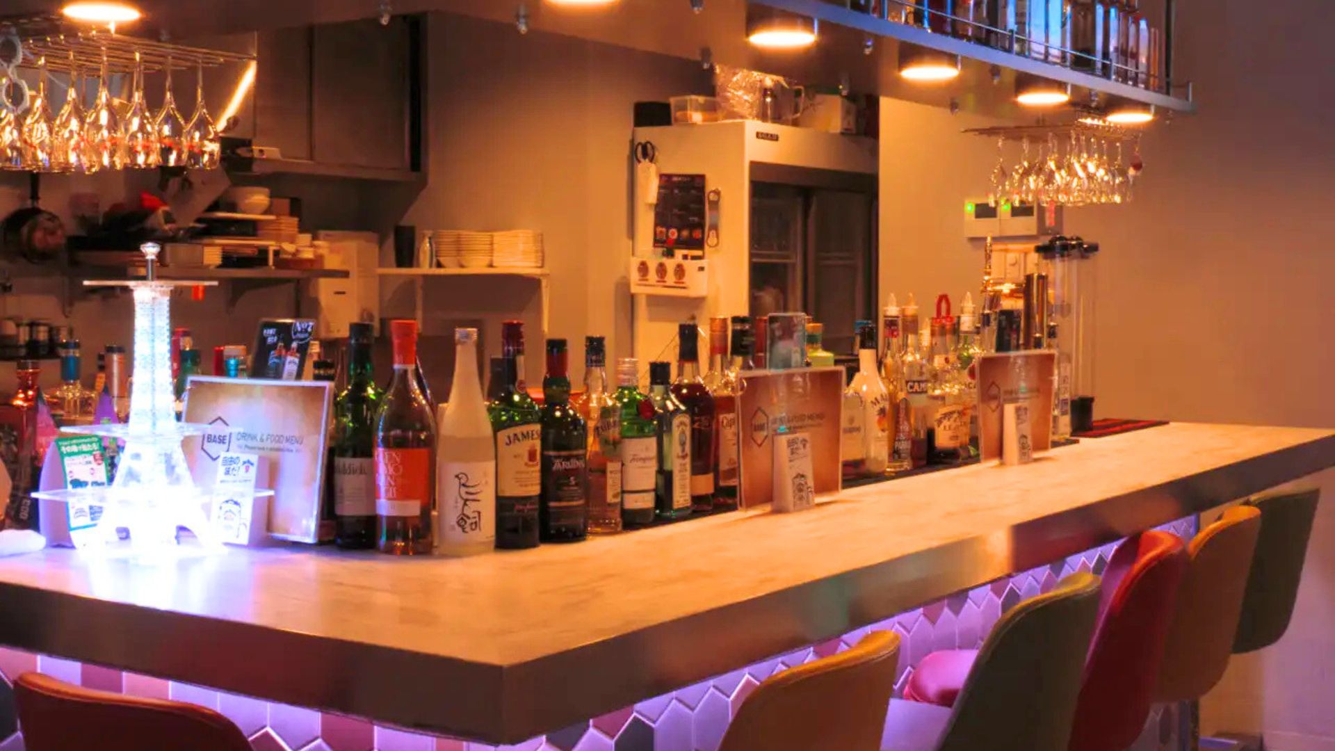 ダーツ&ビアポン BASE2 新宿歌舞伎町店に設置されたビアポンテーブル。青く光るテーブルの奥にはダーツエリアが広がる。